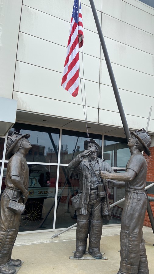 A statue honors firefighters. 