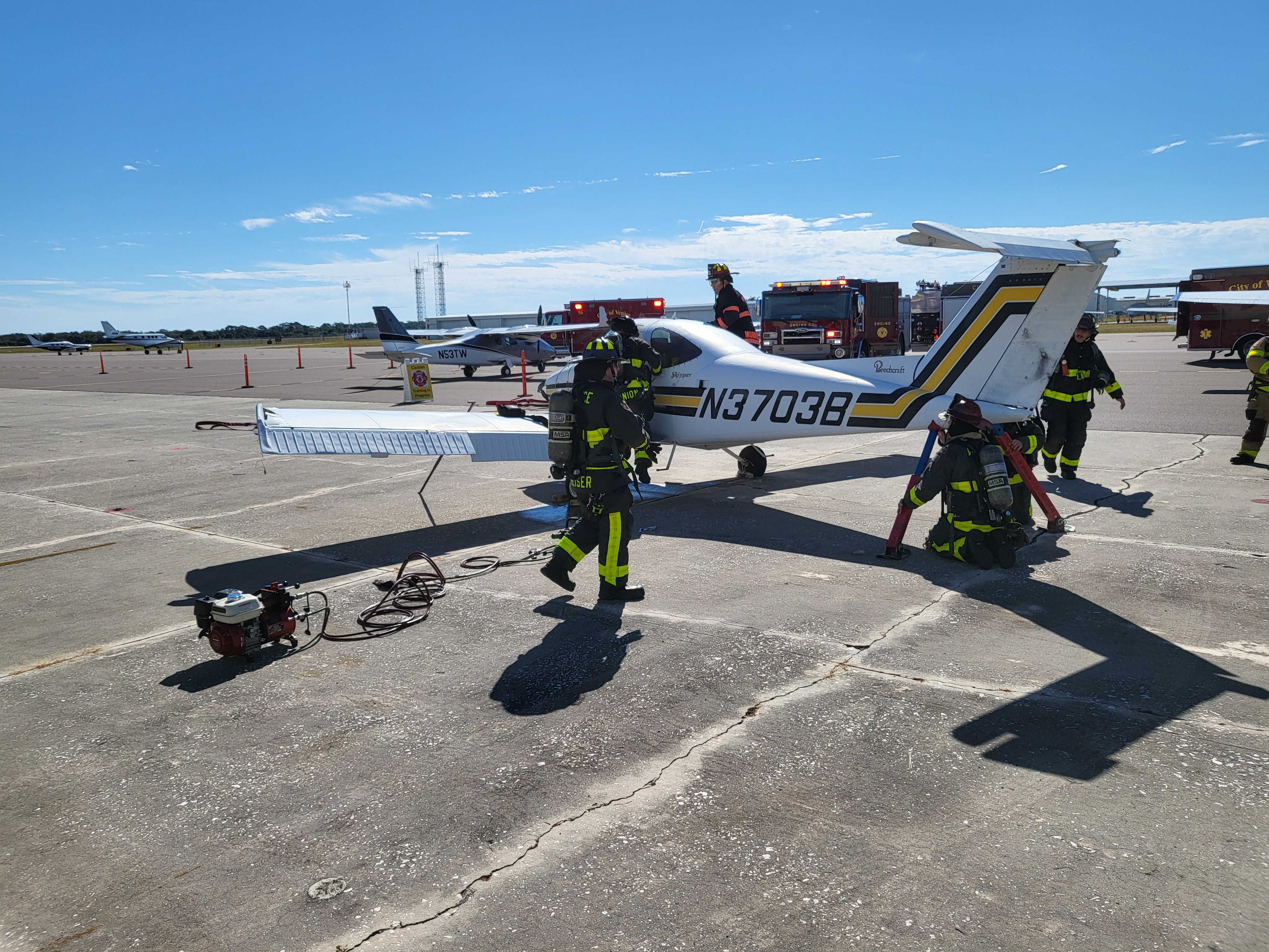 During the initial full-scale exercise session, Venice Fire & Rescue personnel stabilize a disabled Beechcraft Skipper, donated by the Florida Flight Training Center, while establishing scene control and mitigating hazards within the Incident Command System (ICS) framework.