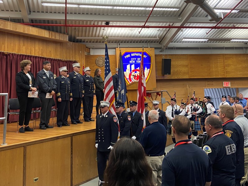 The FDNY EMS Pipes and Drums Band and color guard present the colors.