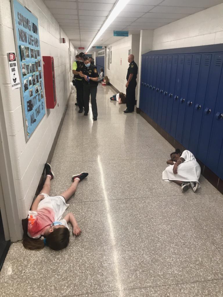 team moving down hallway of victims