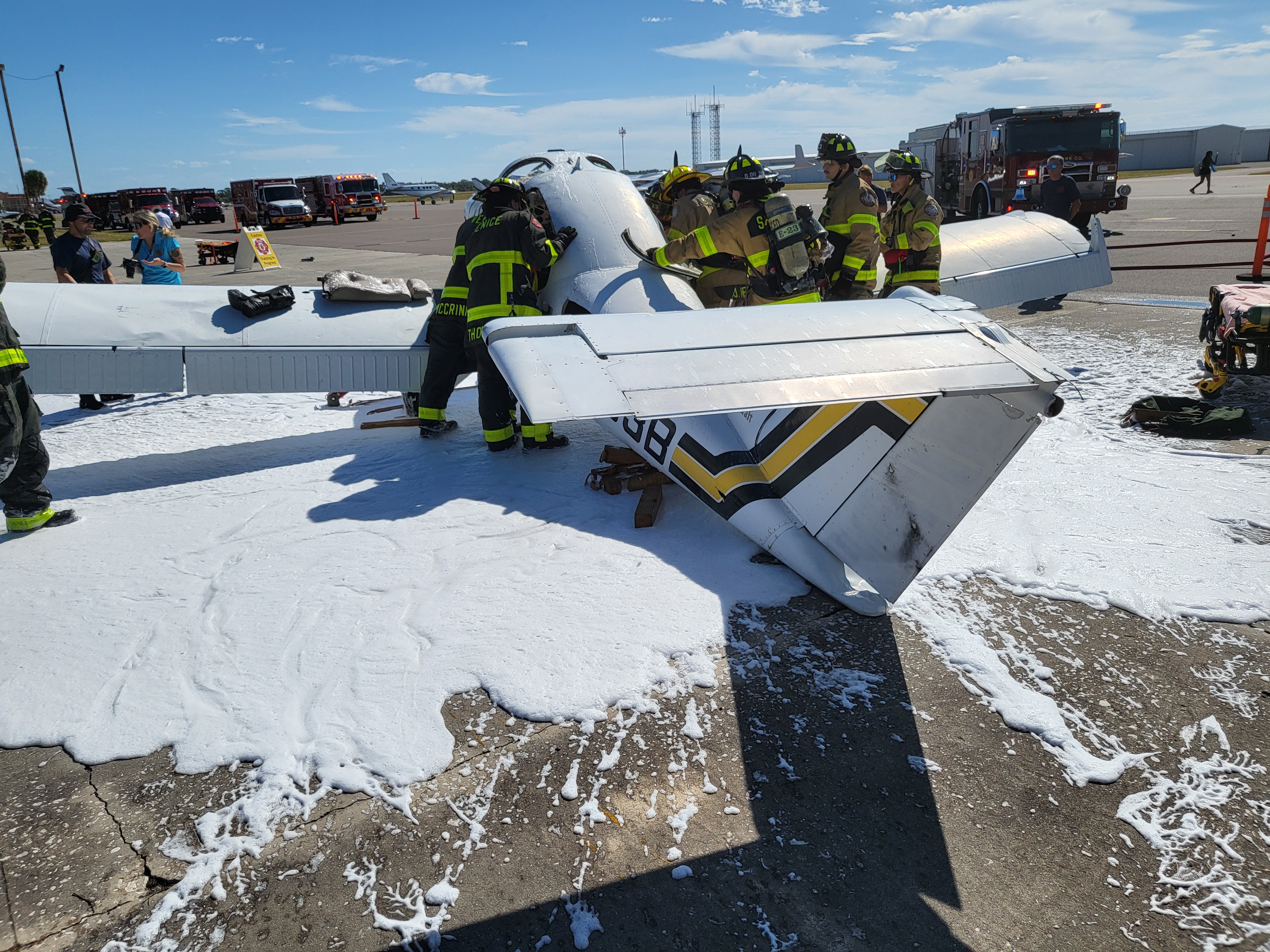 Crews conduct controlled extrication, systematically breaching the airframe while balancing patient protection, responder safety, and the dynamic hazards associated with fuel and confined spaces.