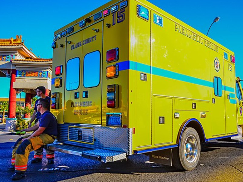 Las Vegas paramedics sit on the bumper of their ambulance