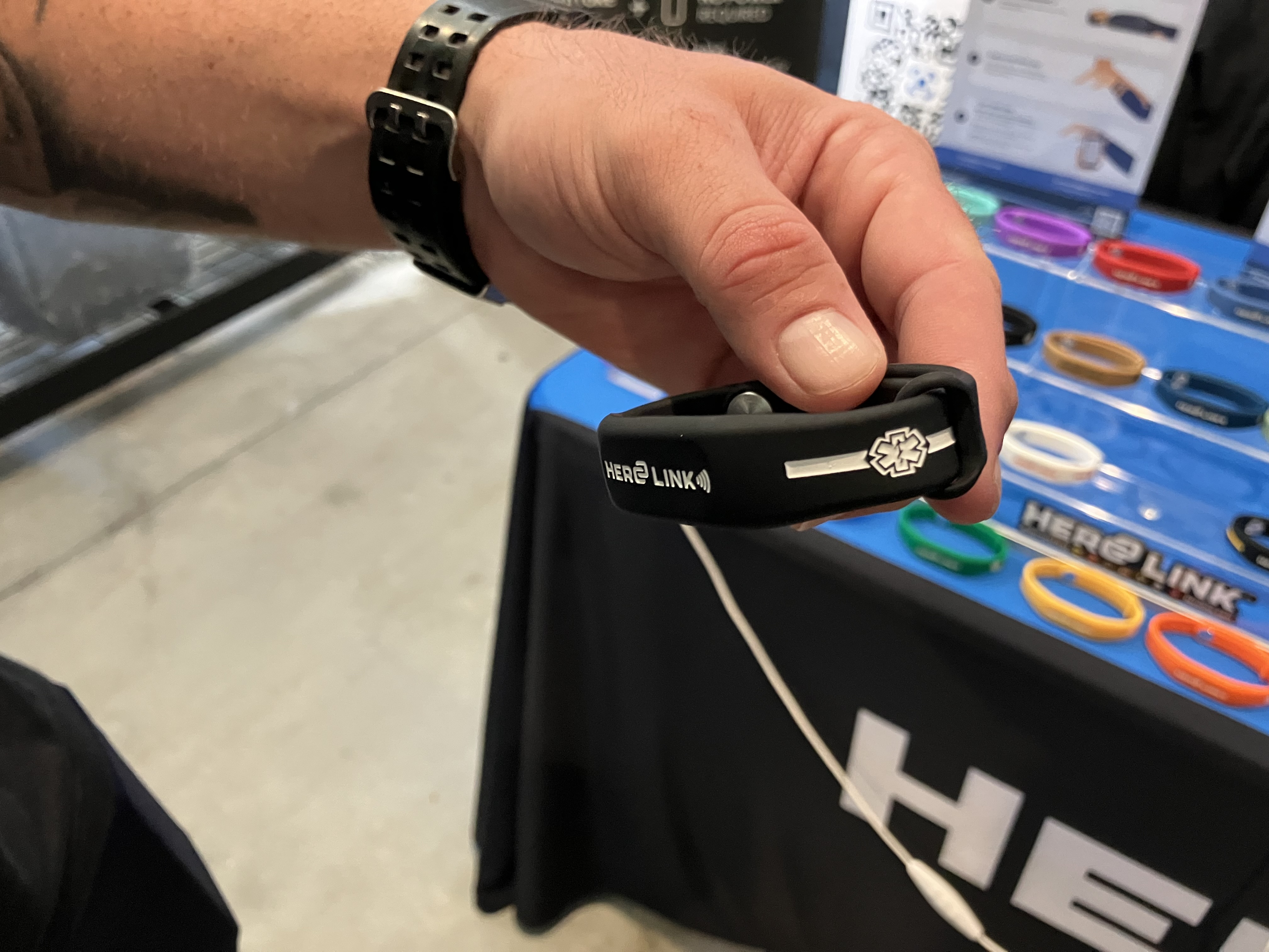 Each Hero Link is colored differently depending on the occupation of the person wearing it. This one shows a symbol for EMS. 