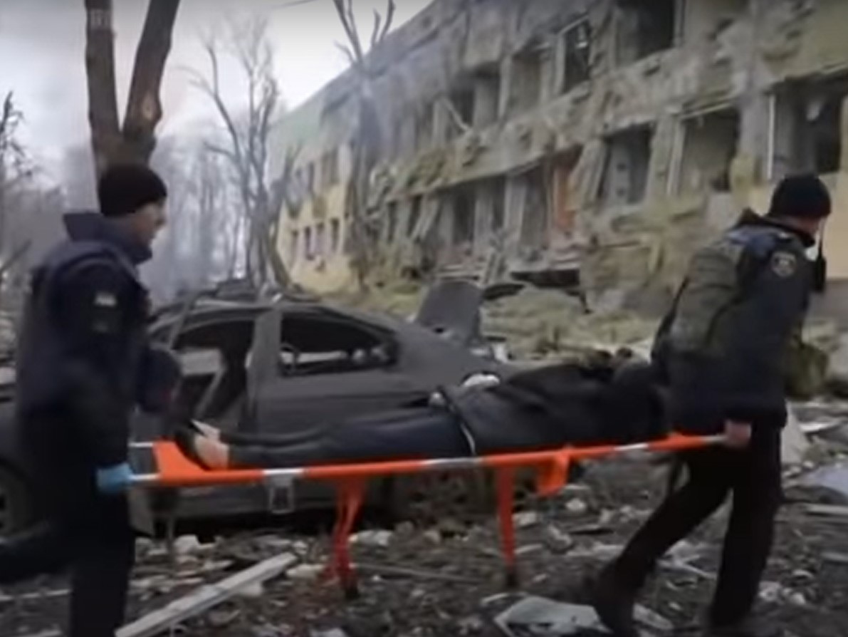 Rescuers move a victim of a hospital bombing in Mariupol. (Photo: AP/YouTube) 
