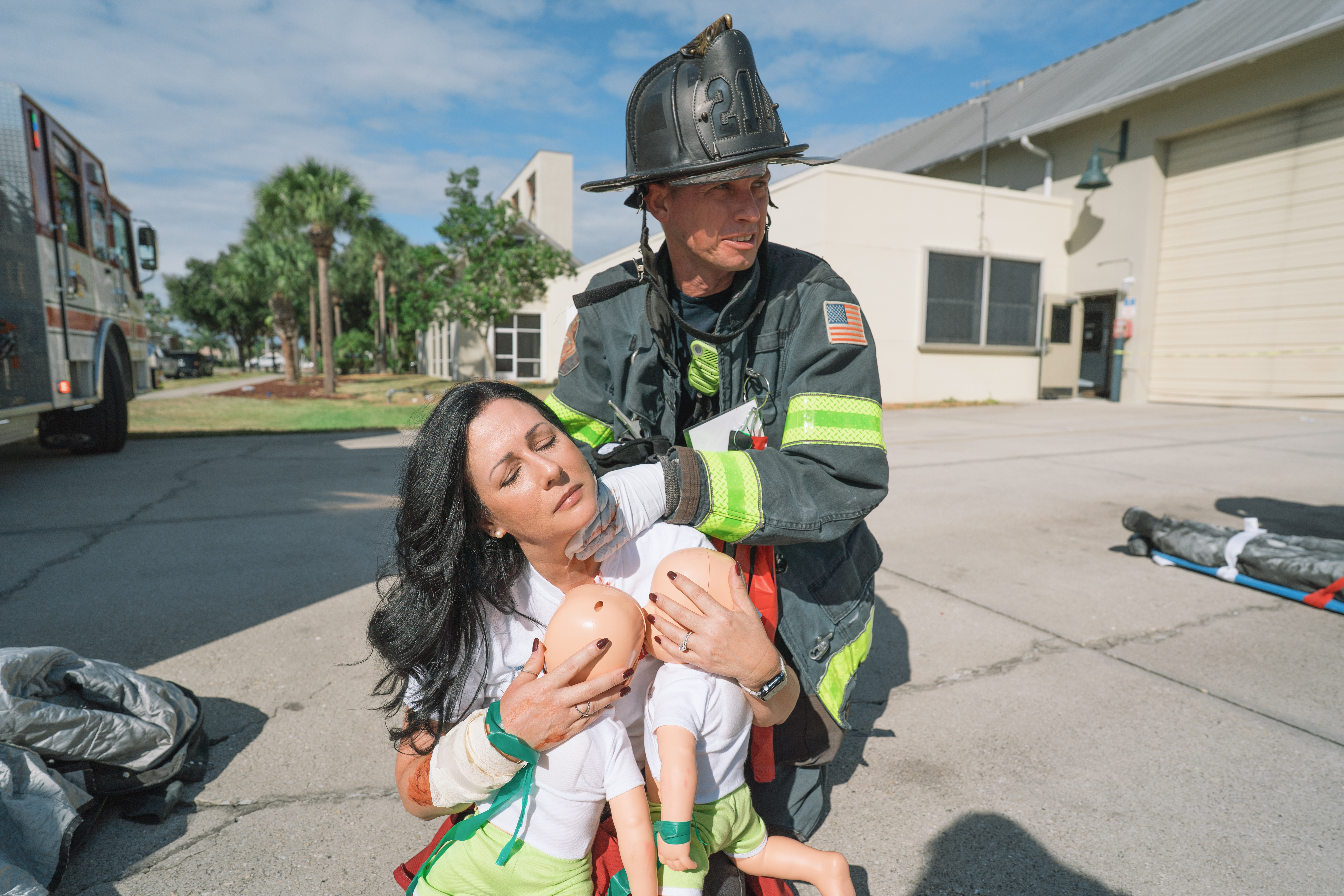 Assessing a volunteer patient with two infants.
