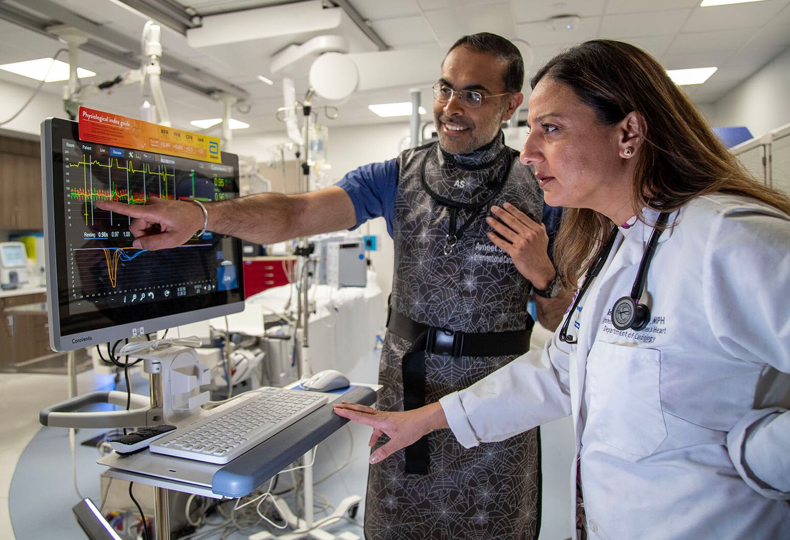Avneet Singh, MD (left), and Nisha Parikh, MD, review pressure tracing that monitors blood flow in the coronary arteries. Photo credit: Northwell Health