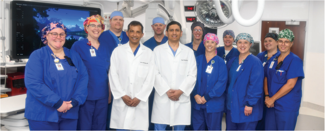 EP Lab Staff. Back row, from left to right: Ryan Meuhlberg, RT(R); Kory Adair, RCES; Alexis Conlon, RN; Melissa Schuster, RCIS; Megan Hutton, RN. Front row: Jennifer Perry, RN; Angela Flitter, BSN, RN; Mevan Wijetunga, MD, ABIM, MBA; Saqer Alkharabsheh, MD; Theresia Rieger, RCIS Lead; Stacey Falch, RRT; Shannon Rud, RN, Cath/EP Lab Supervisor. Not pictured: Ali Gjesdal, NP.  