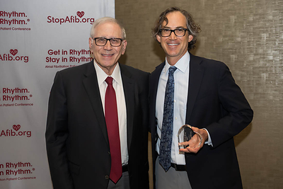 Dr. Eric Prystowsky, (left) presents the award to Dr. Jonathan Piccini