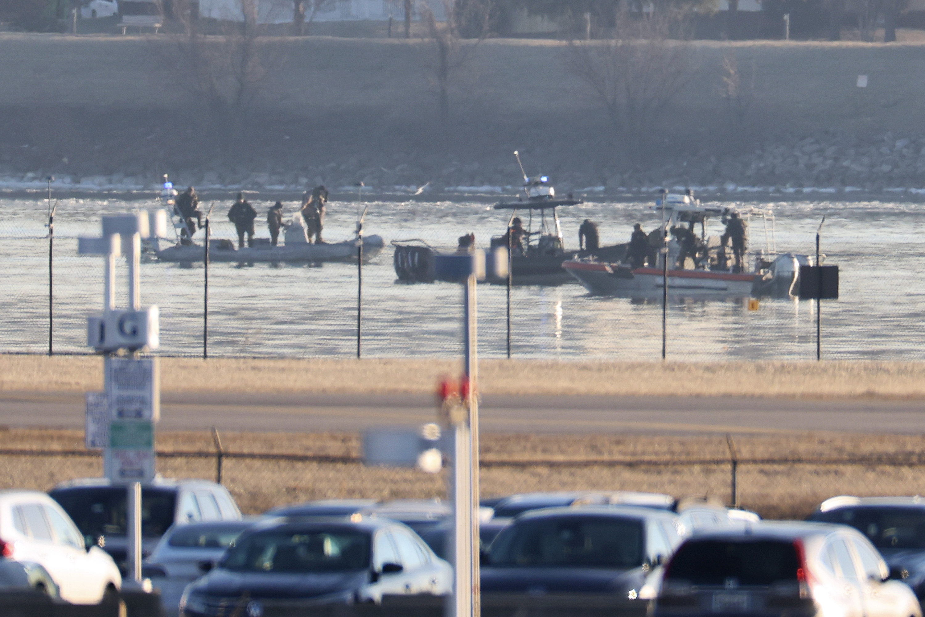 Emergency response units search the crash site of the American Airlines plane on the Potomac River after the plane crashed last night on approach to Reagan National Airport on Jan. 30, 2025, in Arlington, Virginia. The American Airlines flight from Wichita, Kansas collided in midair with a military helicopter while approaching Ronald Reagan National Airport. According to reports there were no survivors amongst the 67 people on board both aircraft.
