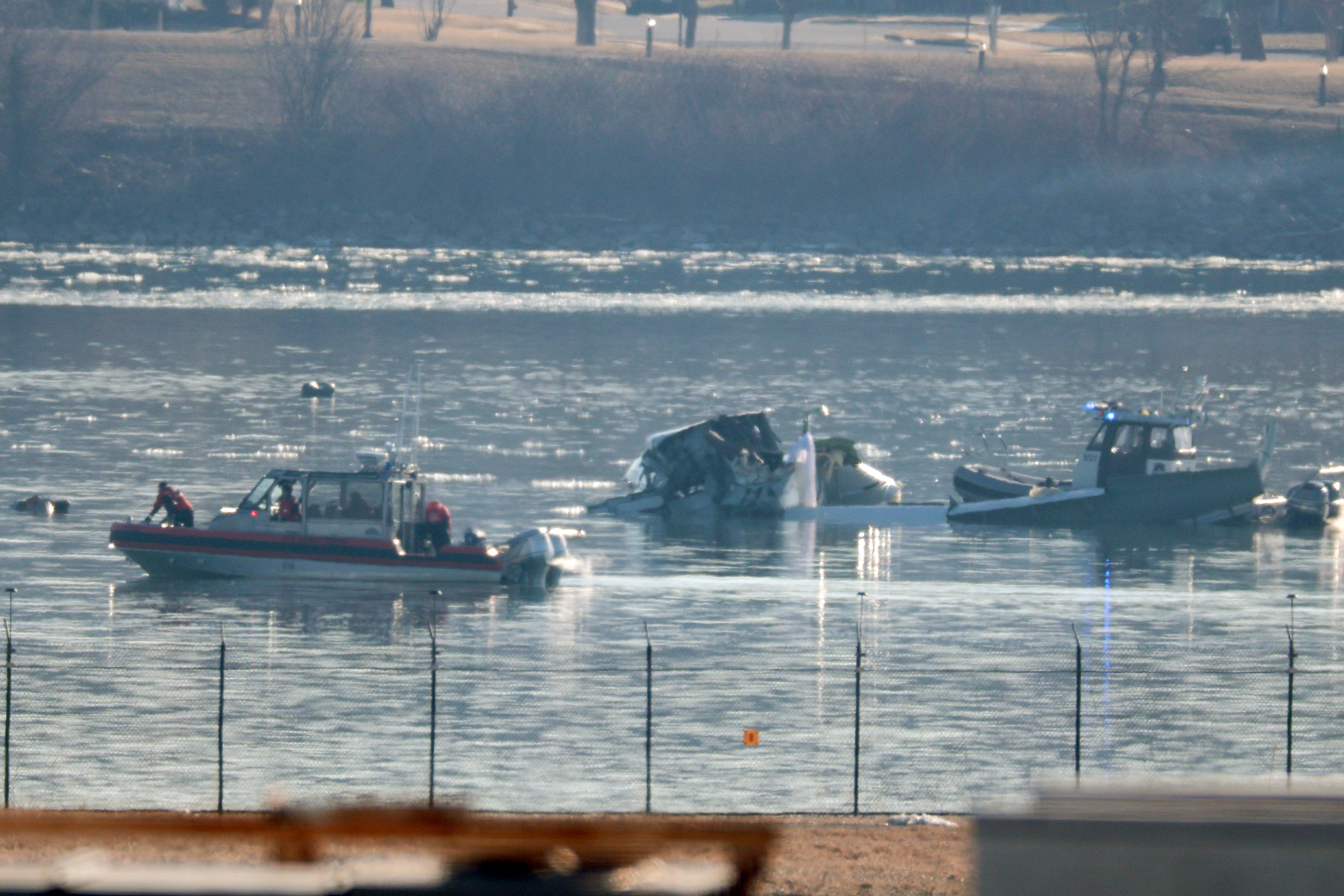 Emergency response units search the crash site of an American Airlines plane on the Potomac River after an accident last night while on approach to Reagan National Airport on Jan. 30, 2025, in Arlington, Virginia. The American Airlines flight from Wichita, Kansas collided midair with a military Black Hawk helicopter while on approach to Ronald Reagan Washington National Airport. According to reports, there were no survivors among the 67 people on both aircraft.