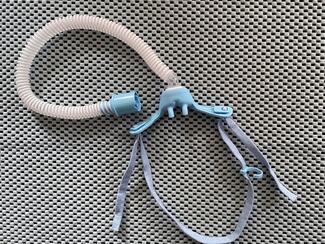A high-flow nasal cannula with tubing and harness. 