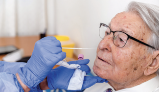 Older man receiving a COVID-19 PCR test