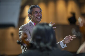 Dr Rakesh Jain conducts the Me2/ Boston string orchestra.