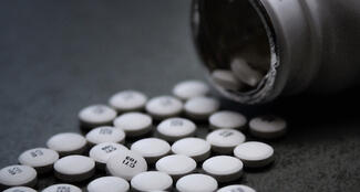 Bottle with pills pouring out