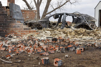 Bricks litter the ground near a car destroyed by the Smokehouse Creek Fire, Thursday, Feb. 29, 2024, in Canadian, Texas. The wildfire has become the largest in state history at over one million acres. (Elías Valverde II/The Dallas Morning News/TNS)