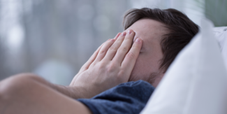 a man struggles to sleep