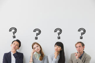 Four people ponder with question marks over their heads