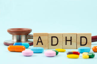 Blocks that spell ADHD with pills and a stethoscope