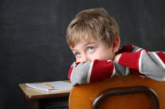 child sitting at a desk