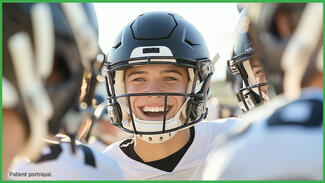 Smiling teenage boy in a football uniform