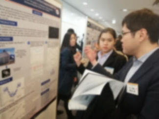 Conference attendees look at a poster