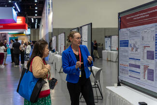 attendees at the 2025 Psych Congress look at a research poster