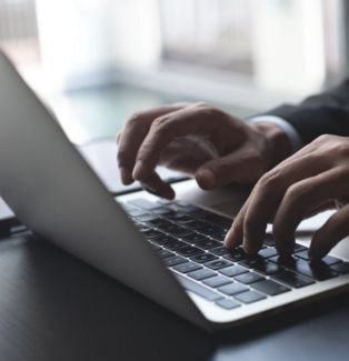 hands typing on a laptop