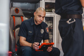 Medic fills out patient documentation on a tablet