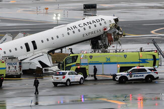 An Air Canada Express CRJ-900 sits on the runway after colliding with a Port Authority fire truck at LaGuardia Airport on March 23, 2026, in New York City. All flights into and out of LaGuardia airport have ben cancelled until 2 P.M. after an Air Canada Express plane flight from Montreal collided with a fire truck on the tarmac killing the pilot and leaving more than forty people injured. (Michael M. Santiago/Getty Images/TNS)