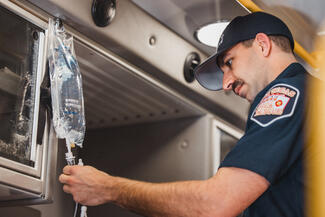 Medic checks a saline bag
