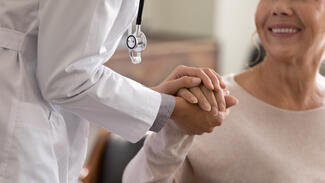 A doctor interacts with an elderly patient