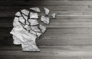 a side profile of a human head, with the top portion appearing to be made of shattered, crumpled paper