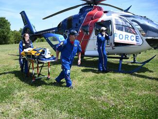 loading a K9 officer into a medical helicopter