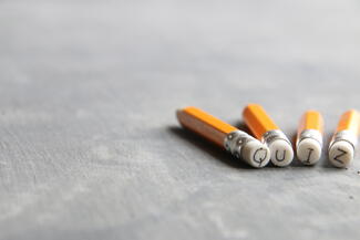 pencil erasers that spell out the word "quiz"