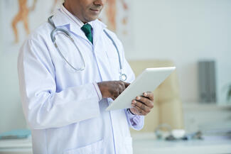 a physician reviews data on a tablet