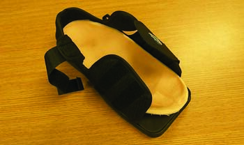 In this photo, one can see a modified Carville healing sandal, where a total contact molded multilayer insole made from a cast of the foot or direct molded from thermoldable material is placed in a surgical shoe, preferably one with a rocker sole.