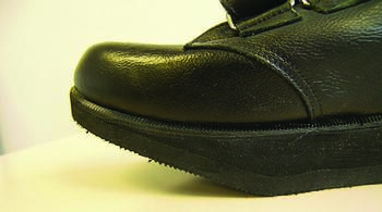 This photo shows a rocker sole shoe with the apex just behind the metatarsal heads. Rocker soles move the apex of the metatarsal rocker into this location, which is normally provided by the metatarsophalangeal joints.